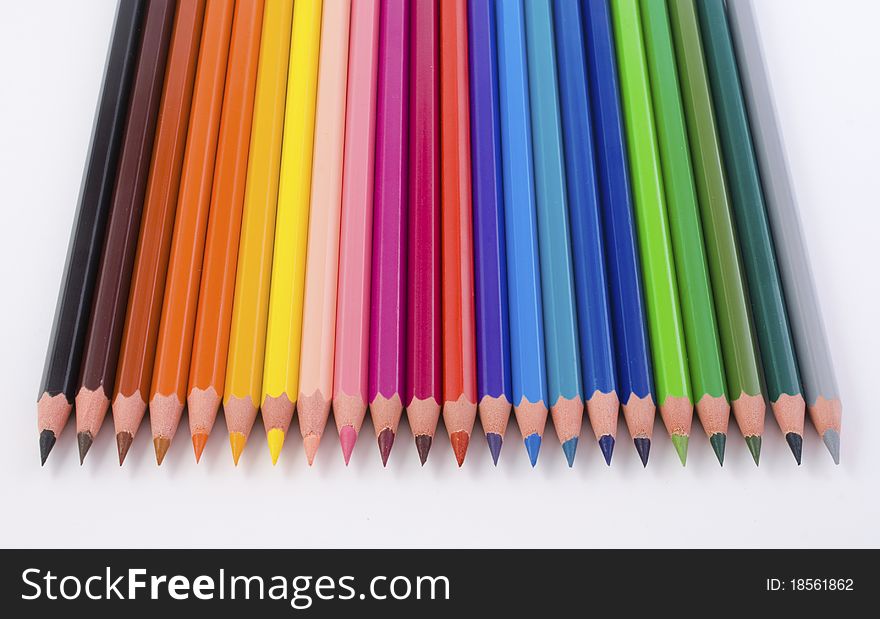 Close-up of colored pencils, top view, on white background. Close-up of colored pencils, top view, on white background