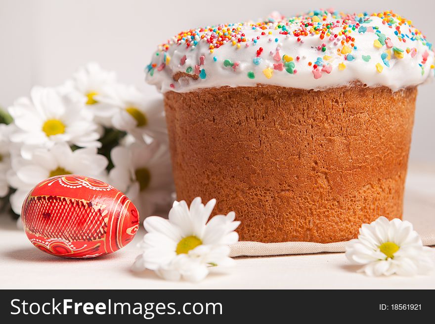 Easter cake and white flowers, red egg