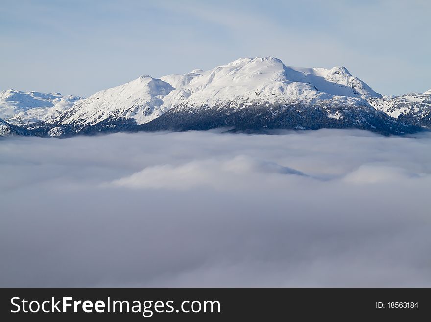 Mountain summits above the clouds in the area near Whistler. Mountain summits above the clouds in the area near Whistler