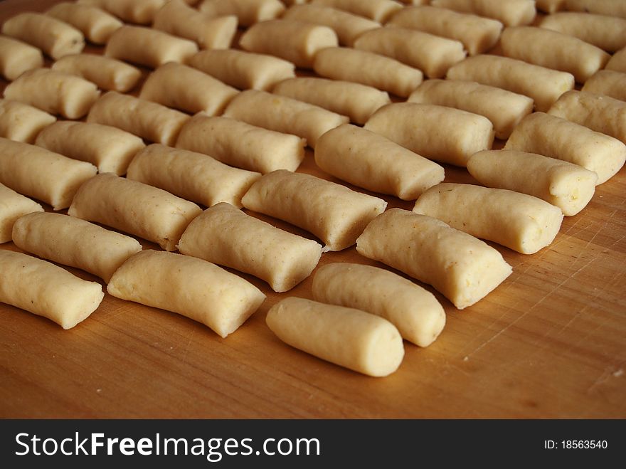 Potato sticks on a wooden pastry board