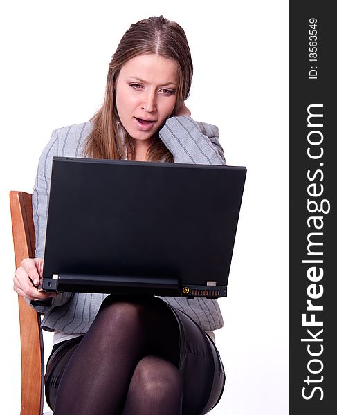 This is the studio portrait of young attractive woman with laptop excited and shouting. This is the studio portrait of young attractive woman with laptop excited and shouting.
