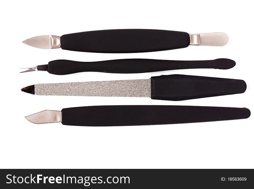 A set of metallic with black handles manicure tools. A set of metallic with black handles manicure tools.