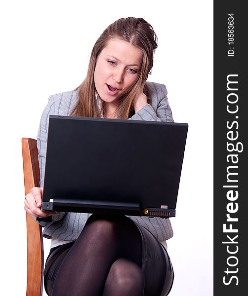 This is the studio portrait of young attractive woman with the black notebook on her lap. This is the studio portrait of young attractive woman with the black notebook on her lap.