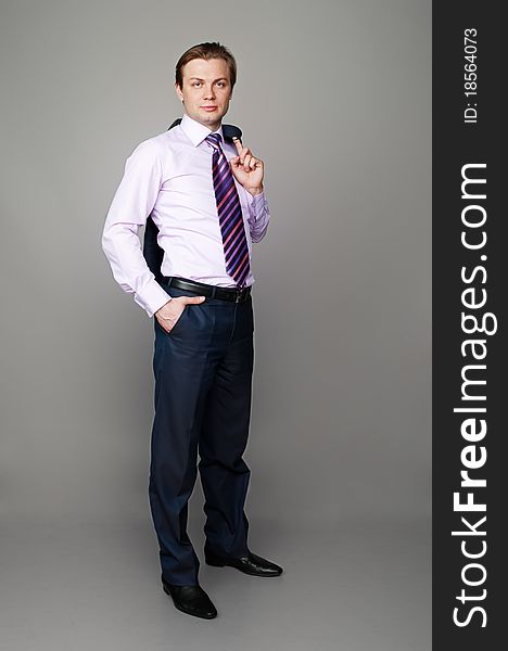 Full length portrait of a young man isolated on gray background. Full length portrait of a young man isolated on gray background