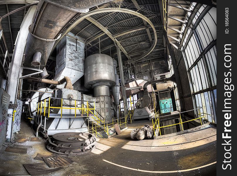 A panorama of the interior of an abandoned power station. Incoming sunlight creates a dramatic scenery, knowing people had a good job here, before the crisis. A panorama of the interior of an abandoned power station. Incoming sunlight creates a dramatic scenery, knowing people had a good job here, before the crisis.