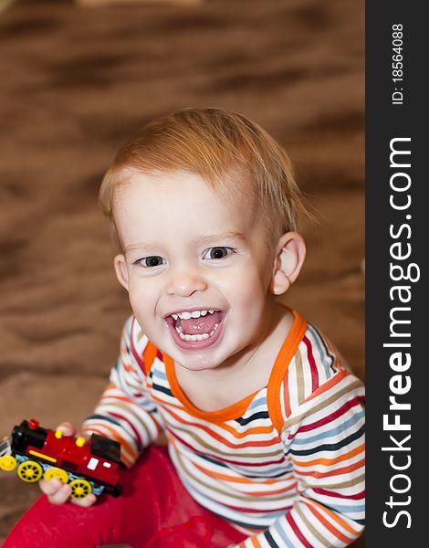 Happy young boy with toy