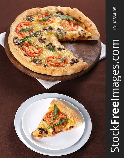 Fresh baked pizza with mushroom, tomatoes and rucola. Fresh baked pizza with mushroom, tomatoes and rucola
