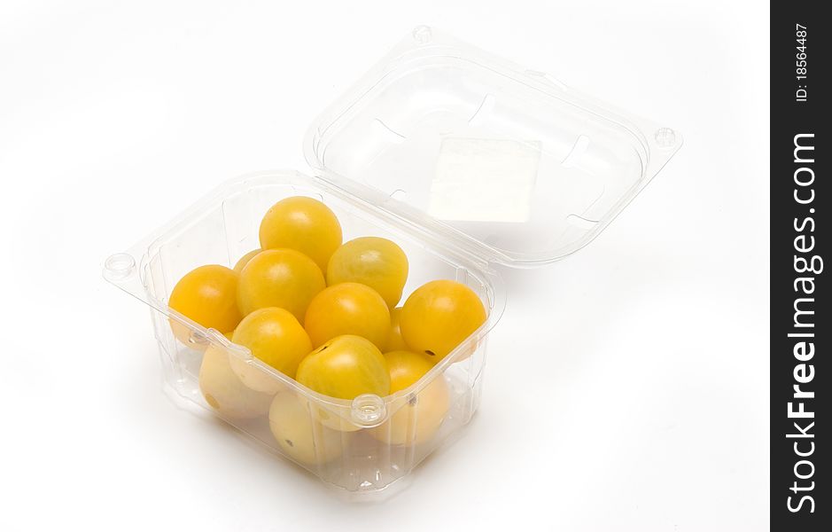 Packaged yellow cherry tomatoes on a white background.