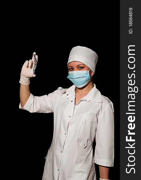 Surgeon holding plate for osteosynthesis isolated on black