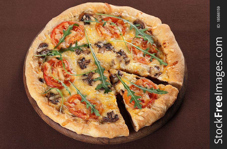 Fresh baked pizza with mushroom, tomatoes and rucola. Fresh baked pizza with mushroom, tomatoes and rucola