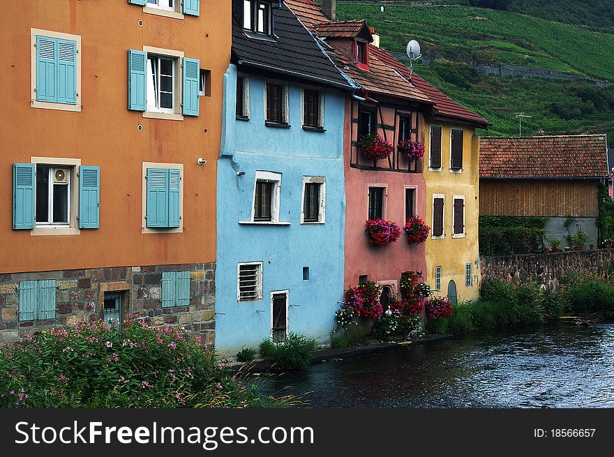 Typical Alsatian colorful houses  by the river, France.