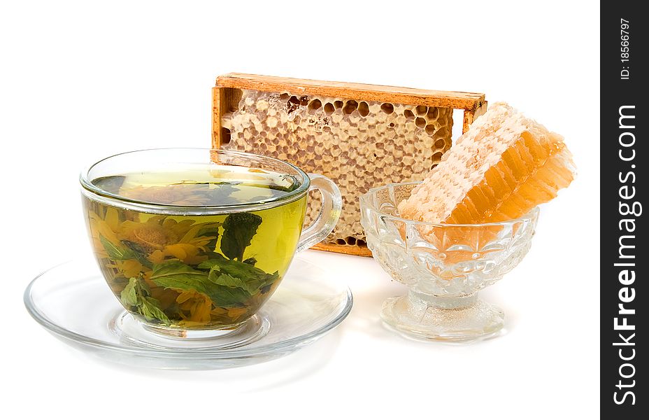 Herbal tea and honeycomb on white background