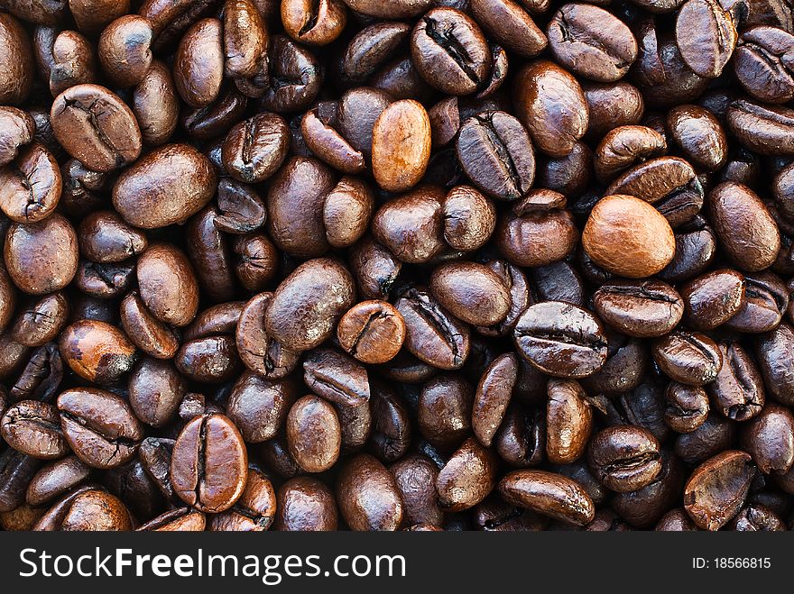 Shiny textured dark brown coffee beans
