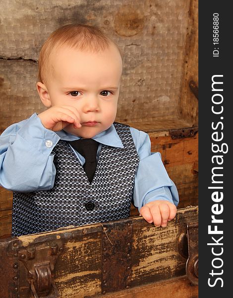 Baby boy playing inside an antique trunk. Baby boy playing inside an antique trunk