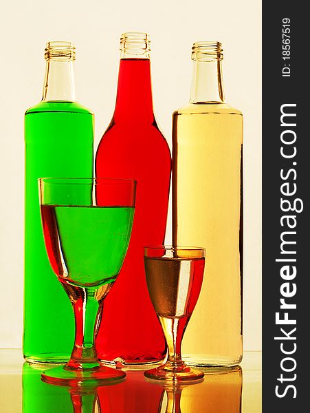 Lemonade in glasses and bottles of red, green, yellow color