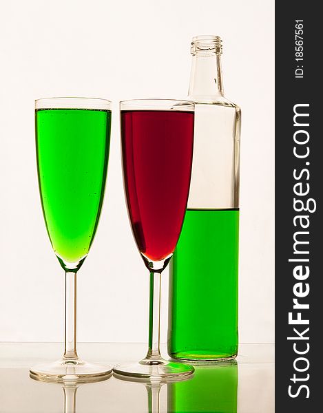 Lemonade in glasses and bottles of green, red color