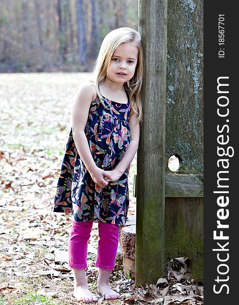 Beautiful little four year old girl outdoors in beautiful print top with pink leggings. Beautiful little four year old girl outdoors in beautiful print top with pink leggings