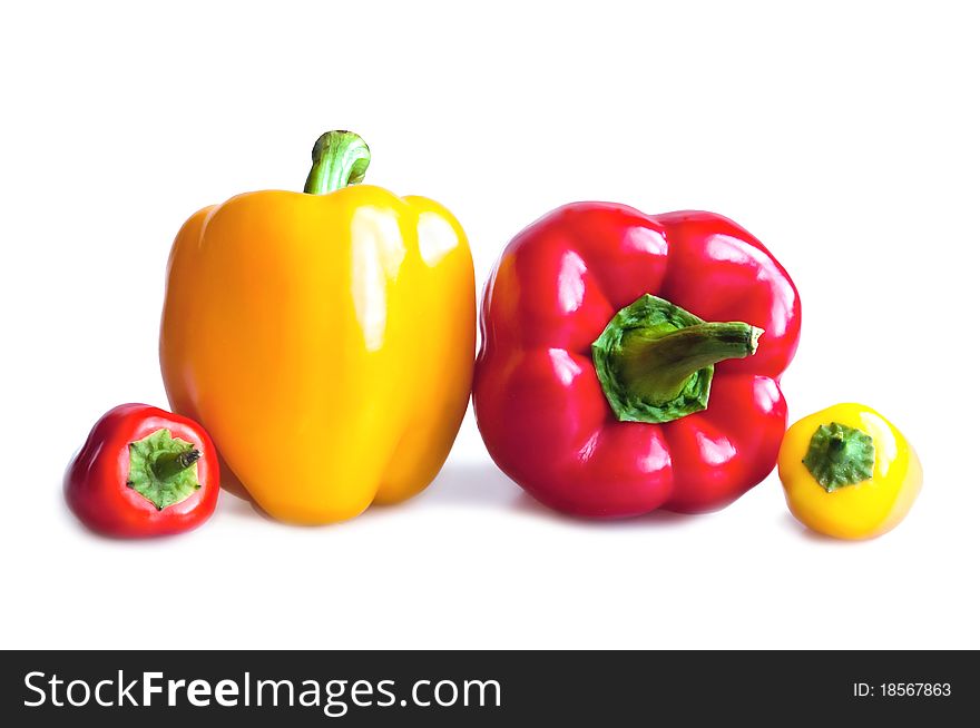 Red and yellow peppers on a white background. Red and yellow peppers on a white background