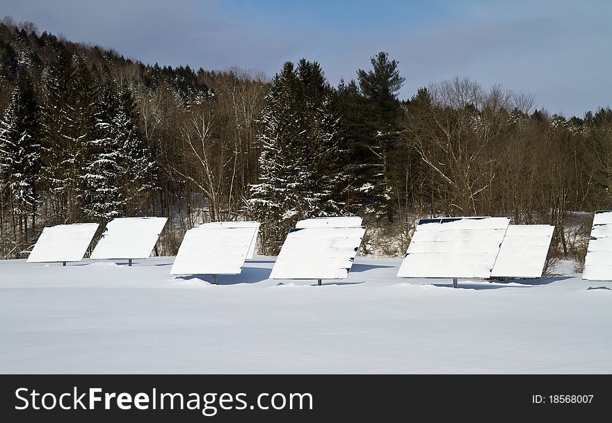 Snow covered solar panels on a winter morning. Snow covered solar panels on a winter morning