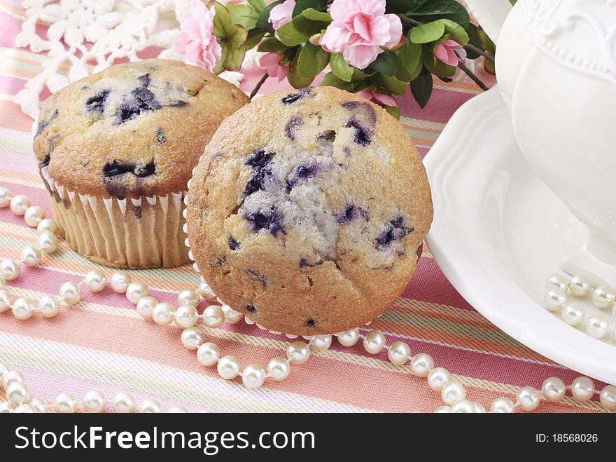 Delicious blueberry muffins with a feminine tea party setting