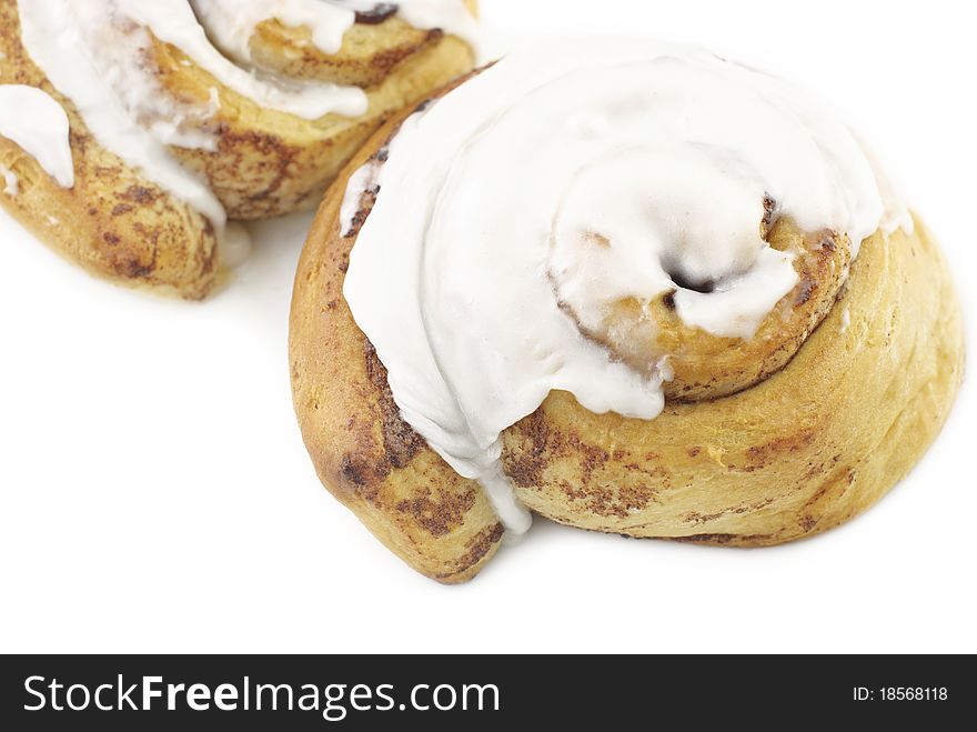 Fresh baked cinnamon rolls with icing, horizontal white background