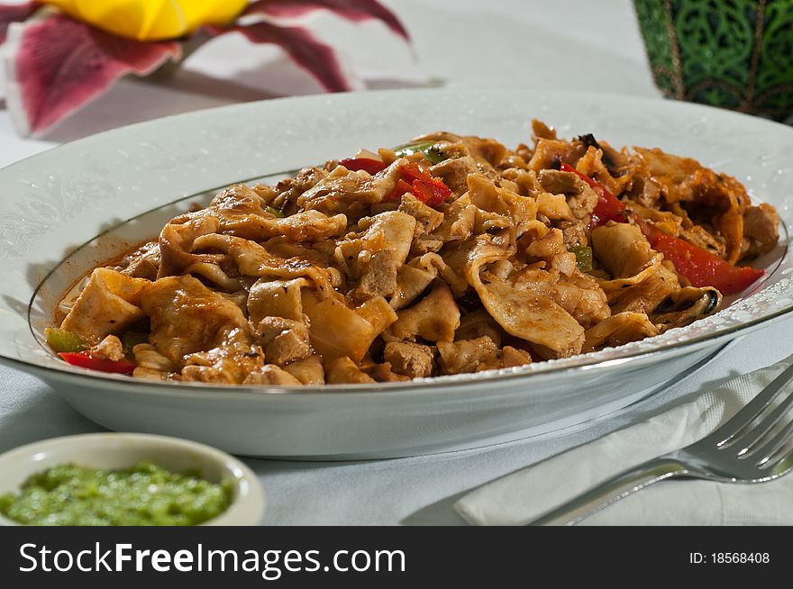 Cooked chicken tossed with noodles of tortilla flour. Cooked chicken tossed with noodles of tortilla flour