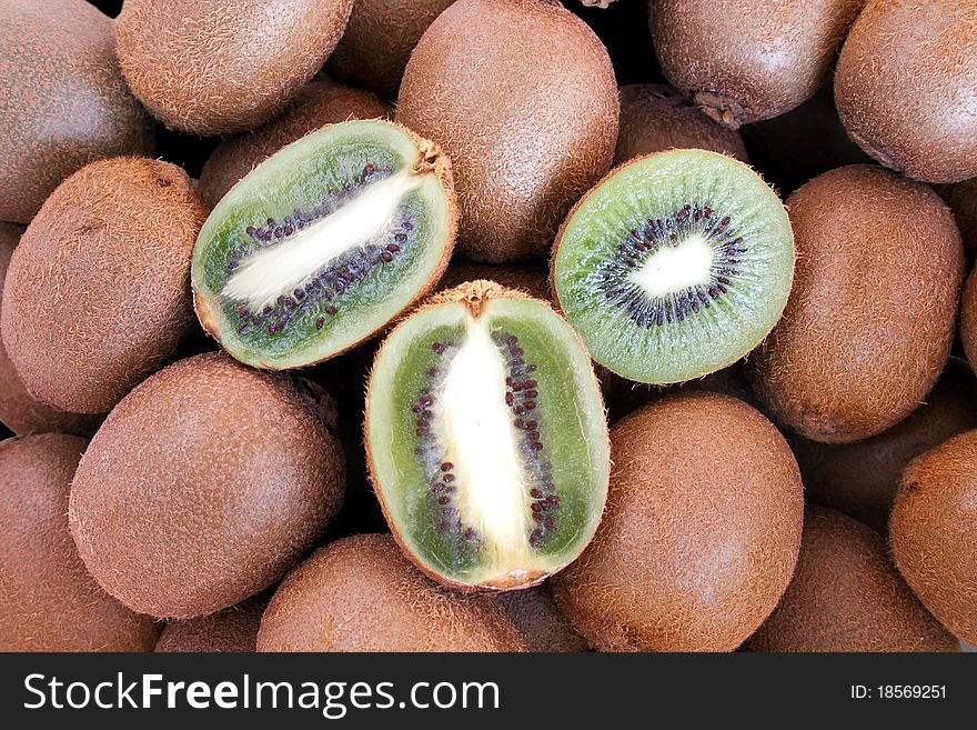 Whole and half ripe fresh kiwi