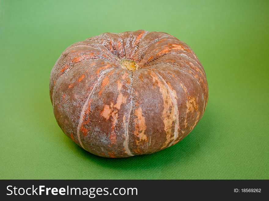 Ripe fresh raw pumpkin isolated on green