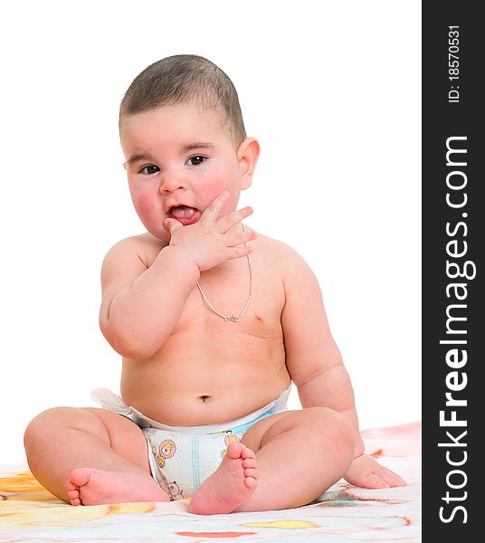 The little boy sits on a rug on a white background. The little boy sits on a rug on a white background