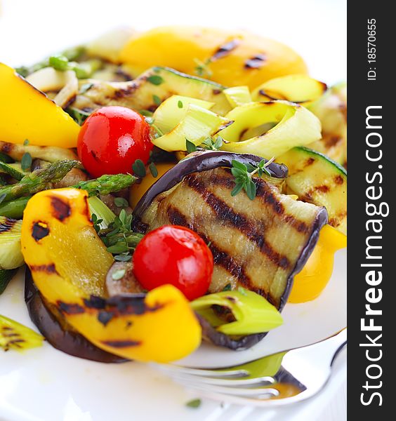 Grilled vegetables on white plate close up