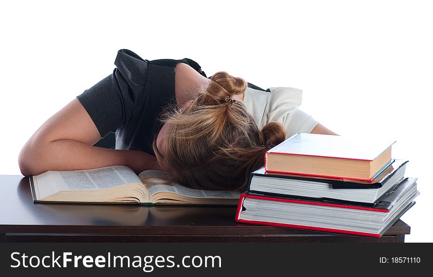 The young student has fallen asleep behind very difficult and boring textbook