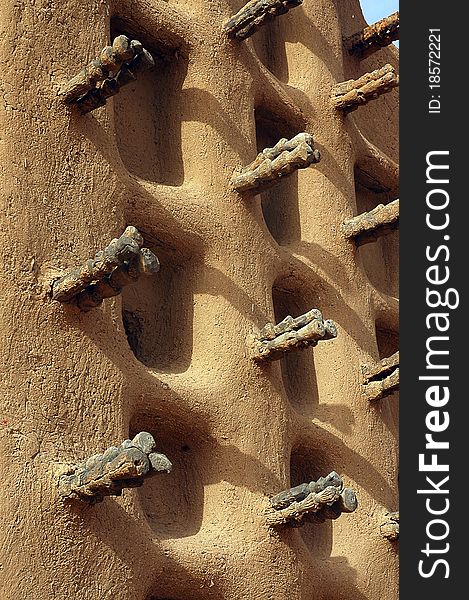 A vertical image of the side wall of a Dogon mud mosque