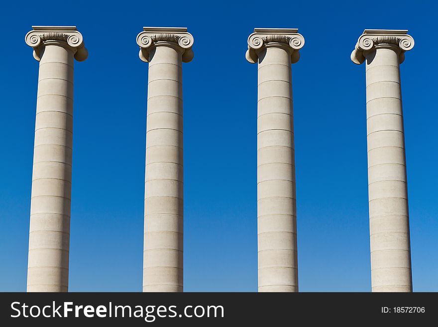 Four massive columns, blue sky