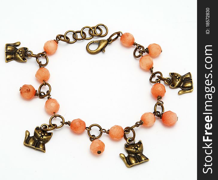 Beautiful bracelet made of coral on a bronze chain white background