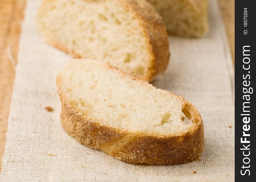 Slices of a homemade bread on a linen tablecloth. Slices of a homemade bread on a linen tablecloth.