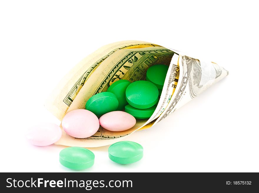 Colored tablets in monetary package is isolated on a white background. Colored tablets in monetary package is isolated on a white background