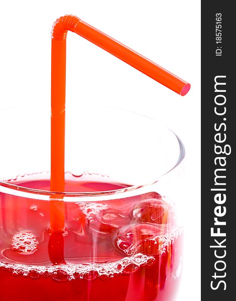 Fresh red berry compote in a glass on a white background