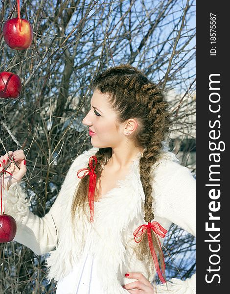 Young beautiful woman on the street, surrounded by apples. Young beautiful woman on the street, surrounded by apples