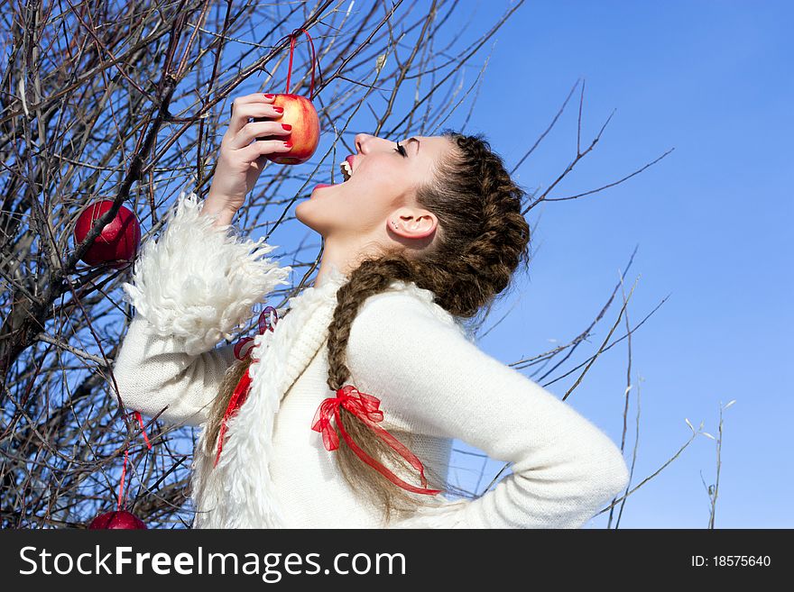 Beautiful young girl relish eating red apple. Beautiful young girl relish eating red apple