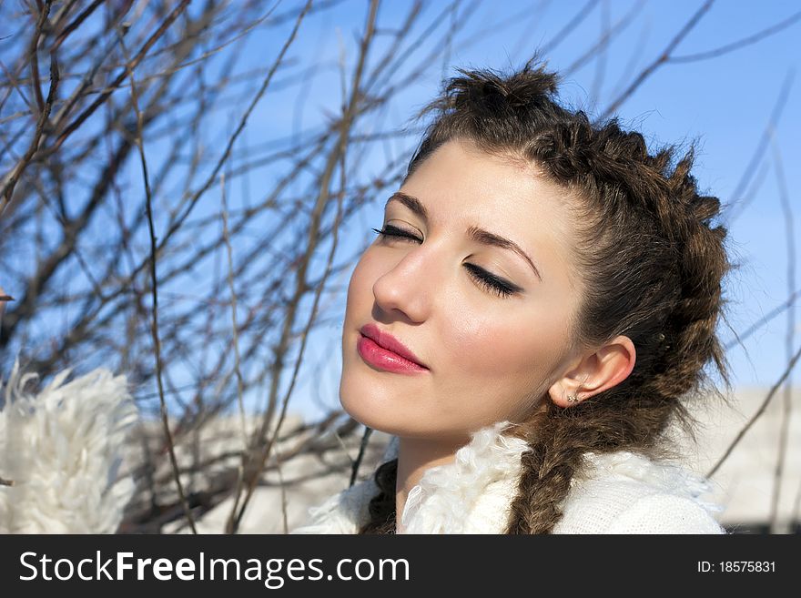 Young brunette woman portrait at sunny winter