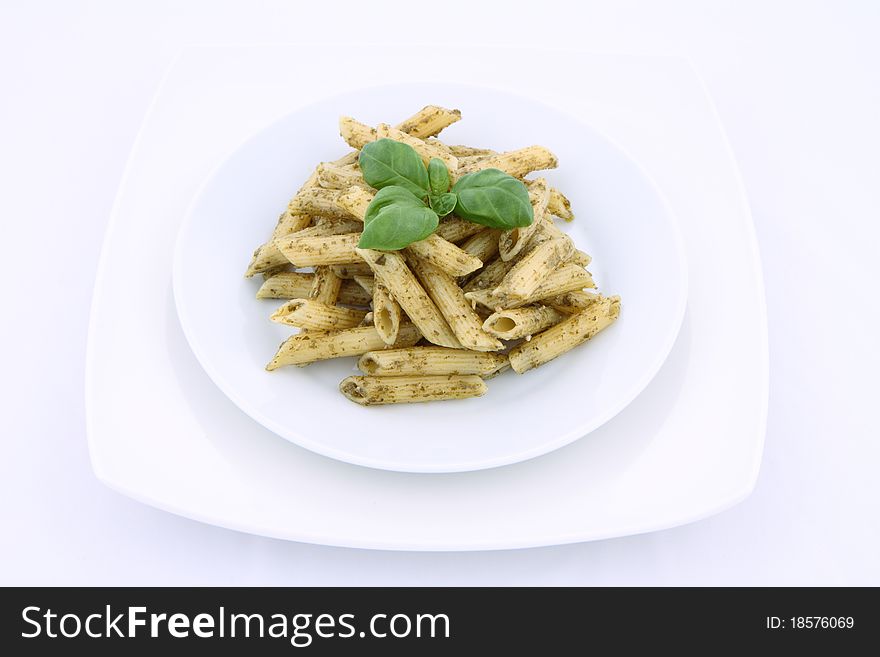 Penne with pesto decorated with basil