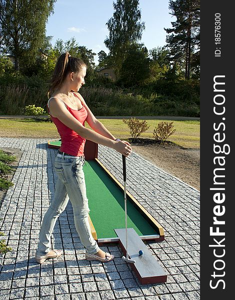 Young woman playing golf in a country club