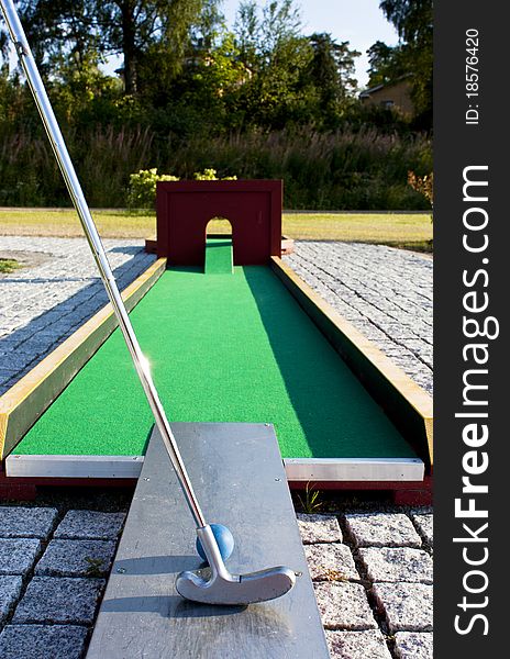 Putting at a mini golf leisure facility.