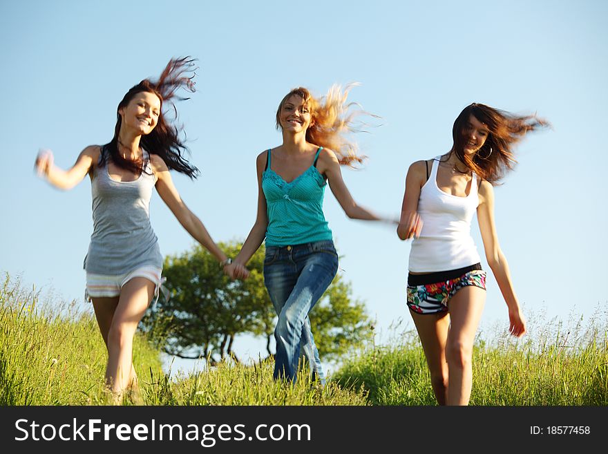 Fun smile girlfriends run by green field sun is shine. Fun smile girlfriends run by green field sun is shine