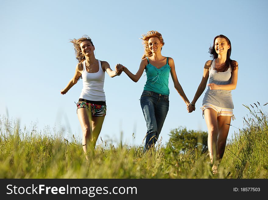 Fun smile girlfriends run by green field sun is shine. Fun smile girlfriends run by green field sun is shine