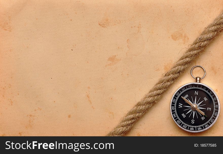 Compass and rope on old paper