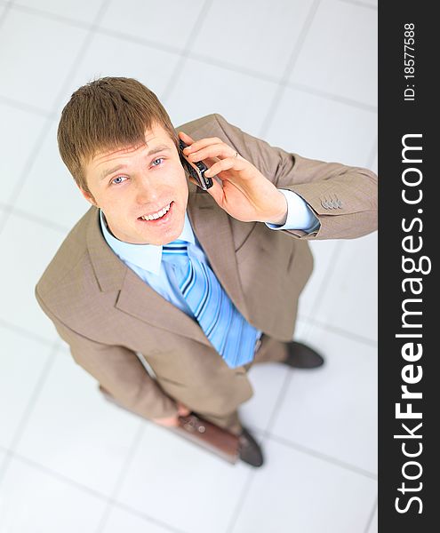 Young businessman on the phone in his office