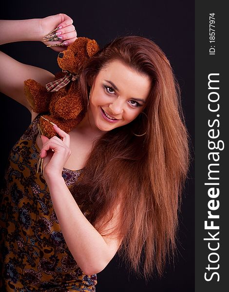 Beautiful longhair girl is holding the teddy bear. Beautiful longhair girl is holding the teddy bear