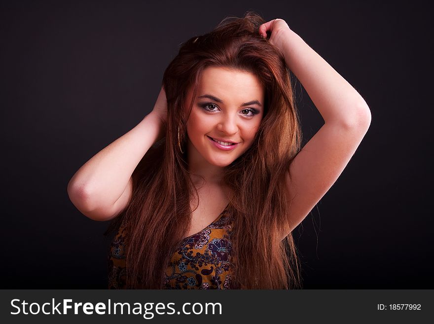 Beautiful young longhair brunette in a romantic pose. Beautiful young longhair brunette in a romantic pose