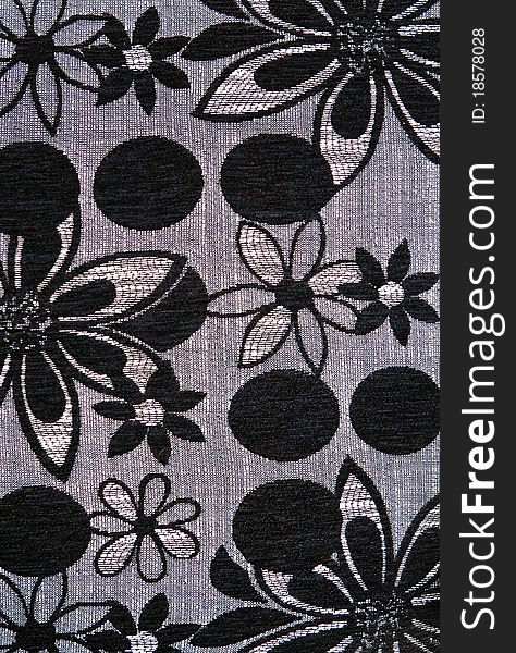 Closeup of retro fabric pattern with black and white floral ornament. Useful for background